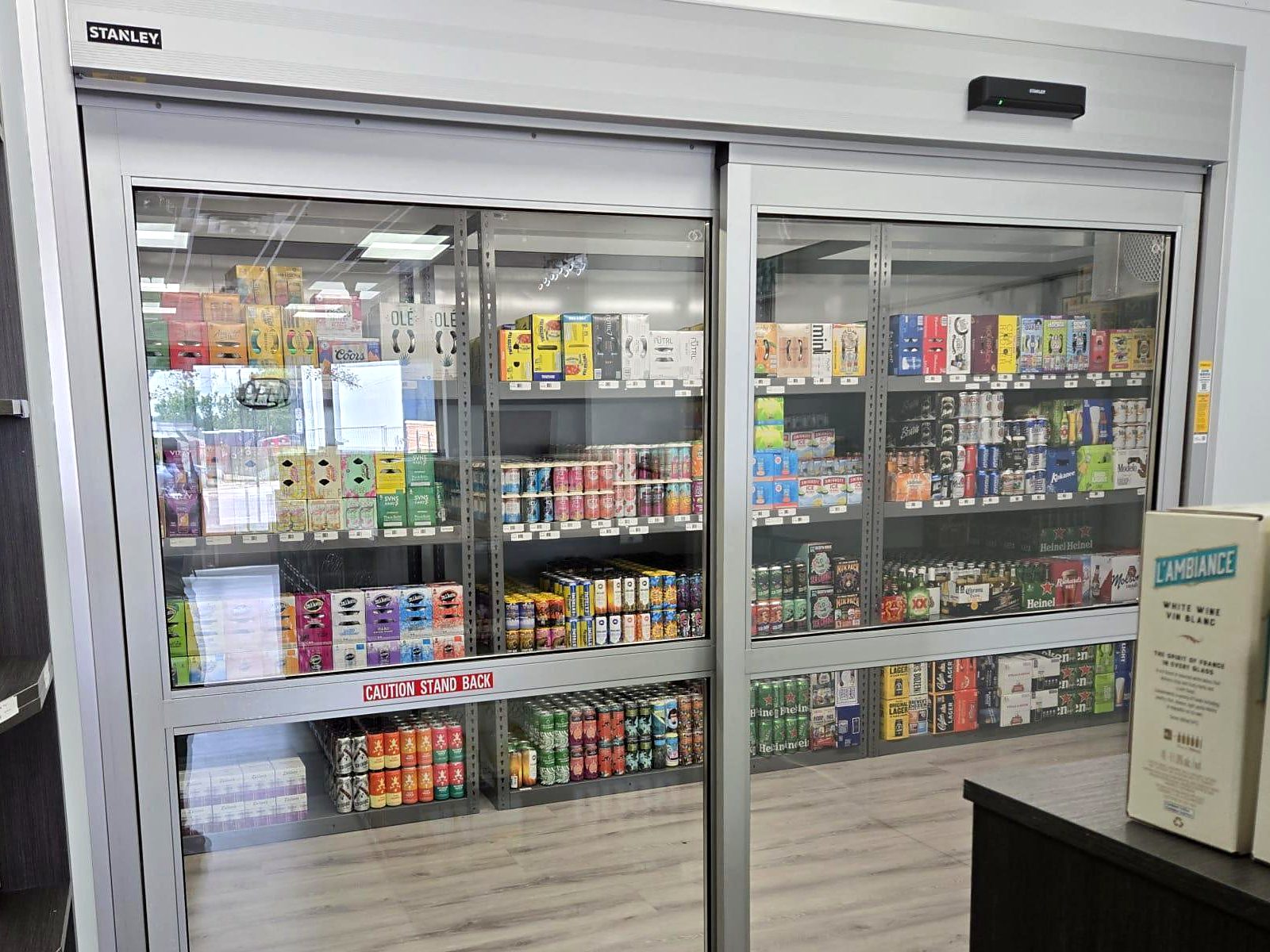 Walk-in beer fridge with sliding glass doors at Select Discount Liquor in downtown Edmonton